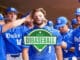 Duke baseball players in blue uniforms in the dugout.