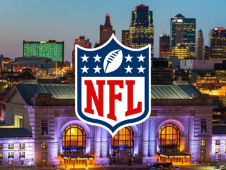 Nighttime city skyline with illuminated building and NFL logo.