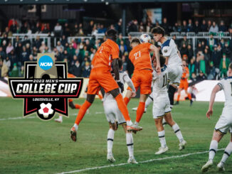 Soccer players celebrating a goal in a stadium.